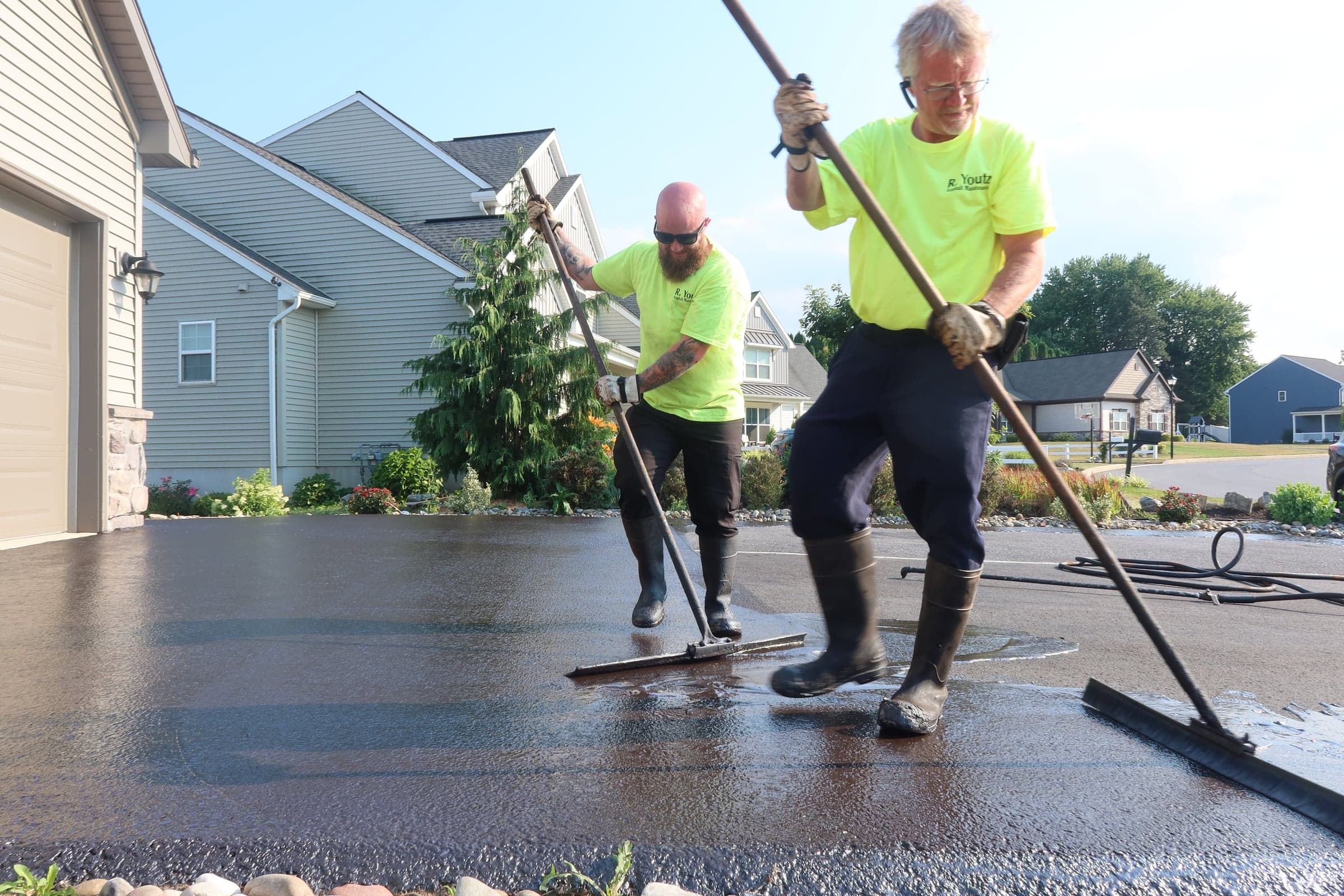 Crew applying driveway sealant — R. Youtz Asphalt Maintenance