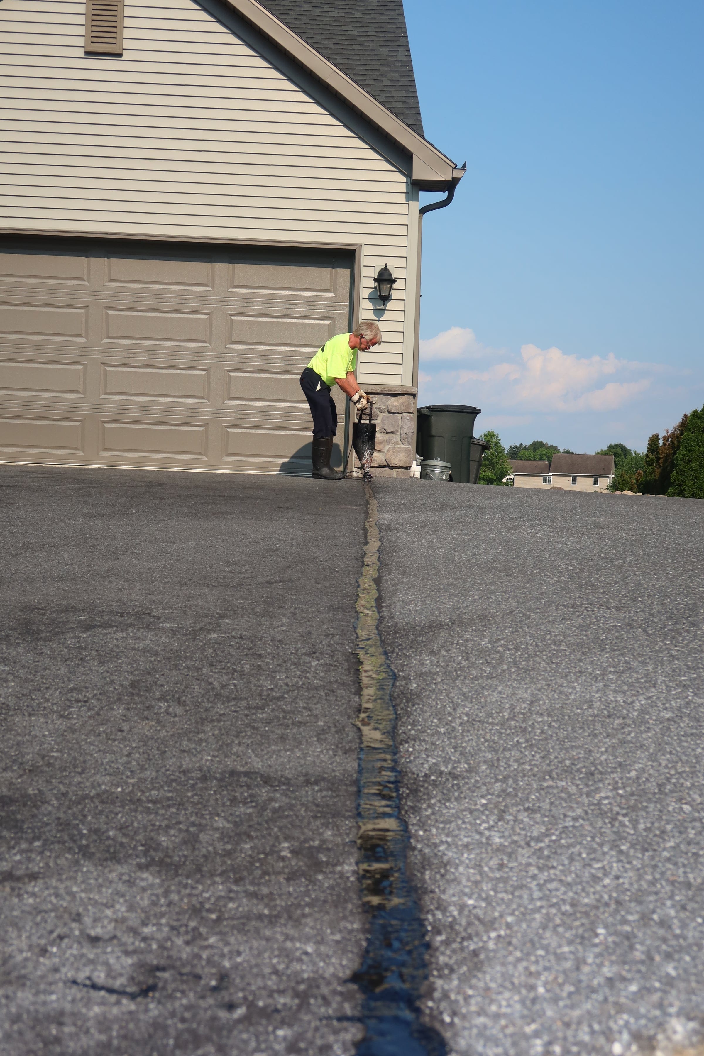 Crack filling with pour pot from R. Youtz Asphalt Maintenance