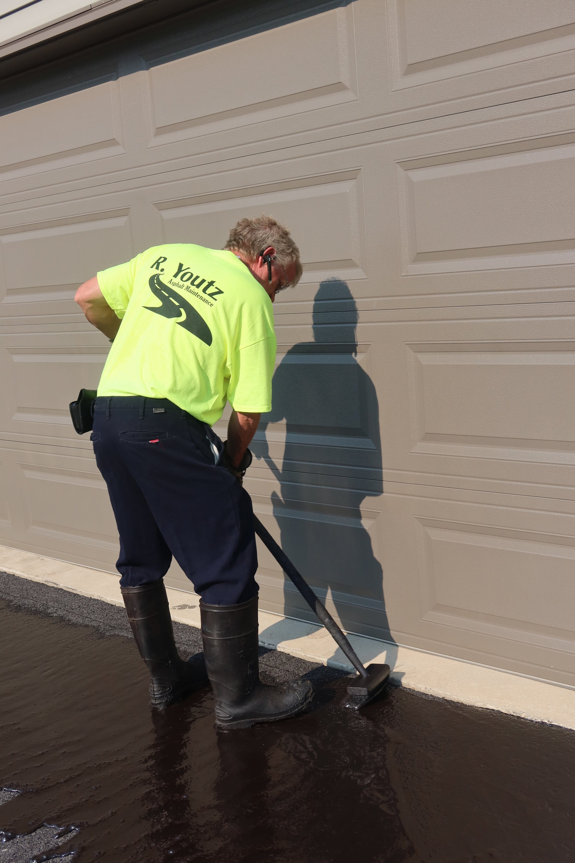 Hand-brushed garage edge from R. Youtz Asphalt Maintenance